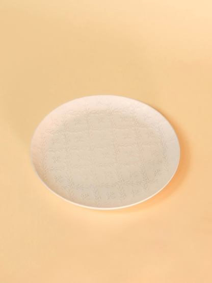 Round light fixture on a beige background