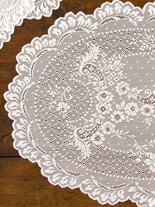 Close-up of a lace doily on a wooden surface