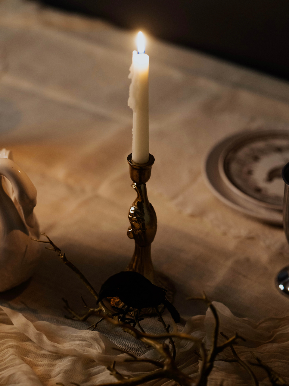 Candle in a decorative holder on a textured surface