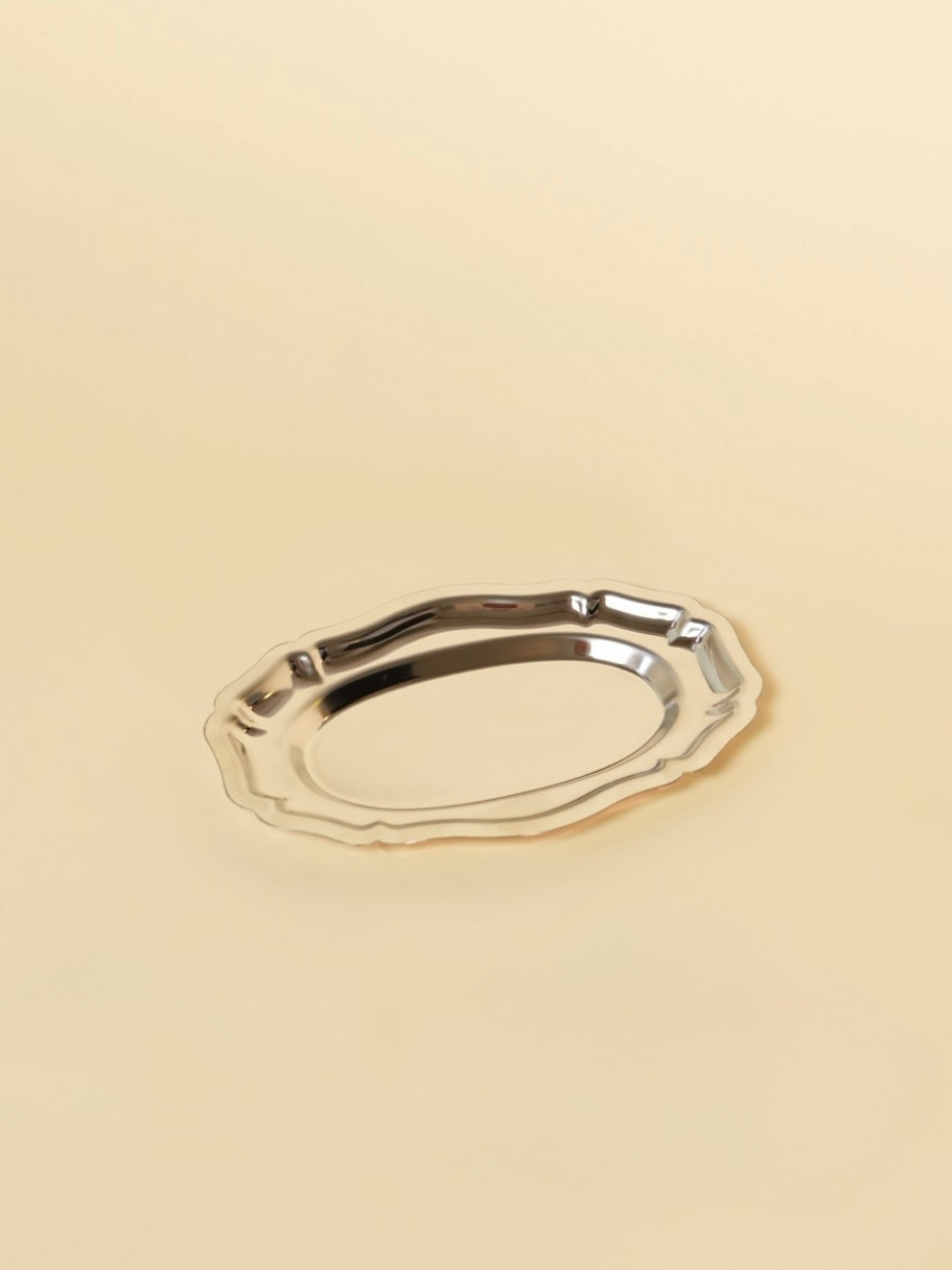 Gold decorative object on a beige background