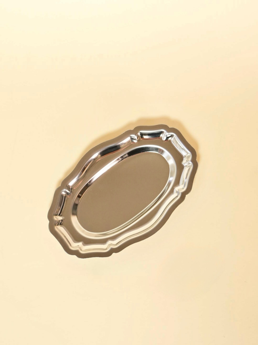 Silver oval tray on a beige background